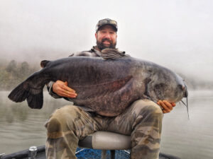 Brian Cabe from Murphy, North Carolina was on his first-ever paid guide trip when he caught this once-in-a-lifetime, 107-pound blue catfish, in the Tennessee River Gorge. (Photo: Capt. Ty Konkle)