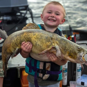 Young Reed doesn’t mind catching flatheads even though he says he likes channel cats best. Either species brings a big smile to his face.