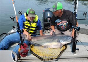 Larry Muse is shown here with his grandson Frankie and his personal best 72-pound blue cat. 