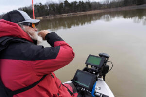 photo of a man looking at his sonar fish finder