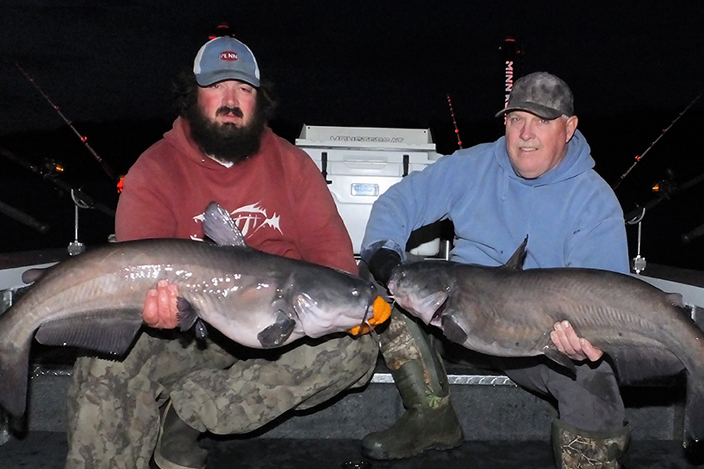 Spencer Hodges and tournament fishing partner Robbie McCoy with blue catfish caught in a shallow water feeding area.