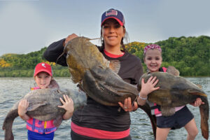 Granata’s wife Meghan and his two daughters, Regan (left) and Taylor (right)  have a thing for catfish too. These photos indicate that they had a good mentor. 