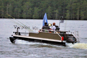 Mark Hamberlin is shown here heading out to fish in his pontoon boat. It provides a stable platform for taking disabled veterans fishing at no charge.