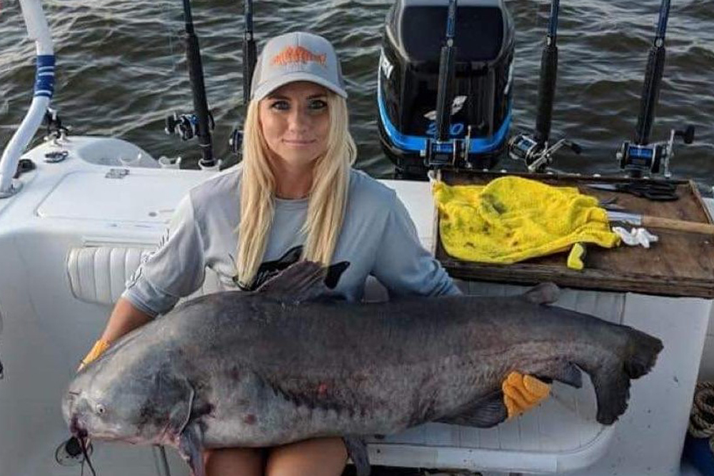 Tiffany “Snookie” Risch landed this 72.8 pound monster blue catfish in July of 2018 while fishing cut baits on the James River with Captain John Garland.