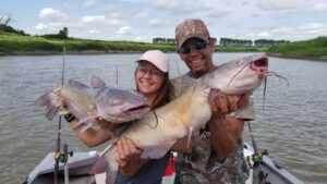 Iowa angler Sarah Zimmerman and her father Clayton with a pair of jumbo channel cats caught on one of the annual fishing trips to North Dakota’s Red River.