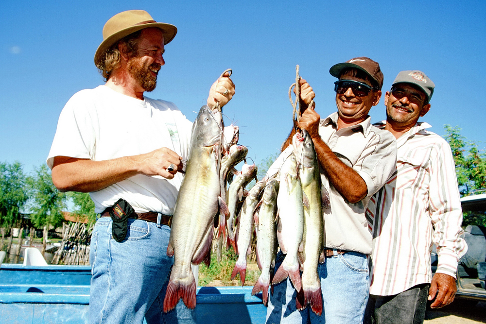 Keith Sutton and his Mexican fishing friends Marcelino and Juan with a mess of catfish caught in Lake Dominguez.