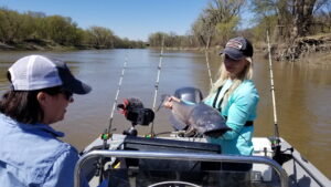 Influencers Hannah Stonehouse Hudson and Nicole Stone bring in a hefty high-water channel catfish. The current seam this fish was caught on was very OFF current. Water temperatures were 49-50 degrees and the spring flood was not yet settled.