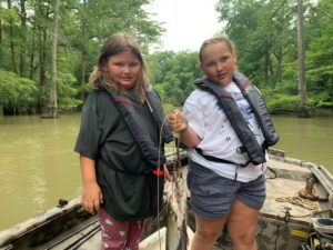 The catfish aren’t big by grown-up standards, but they’re big enough to create some excitement for these two girls.