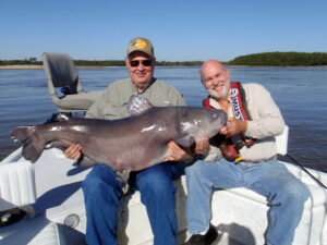 In 2010, outdoor writer Owen Schroeder (left) was just one of many clients Capt. James “Big Cat” Patterson guided to their own “big cats” on the mighty Mississippi River. This monster blue weighed 83 pounds.