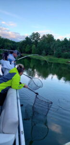 T.J. Gramberg’s young cousin, Ali Whitworth, hooks up with her first catfish, as Gramberg and her husband Lee work the net and offer encouragement. (T.J. Gramberg photo)