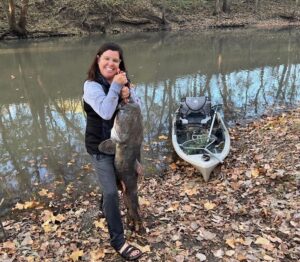 Mary Kay Myers uses a kayak to catch big flathead catfish on the waters of eastern Kansas.