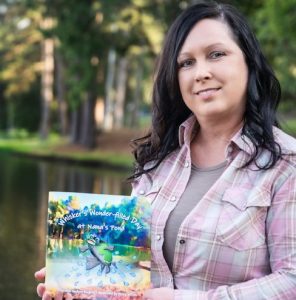 Arkansas author Amy Burgess with a copy of her children’s book, “Whiskers’ Wonder-filled Day at Nana’s Pond.” Illustrator Sheila Jeffries provided the colorful artwork on the cover and inside.