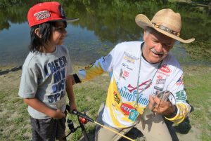 Phil Taunton, a fishing instructor, has helped many Kansas youngsters catch their first channel catfish.