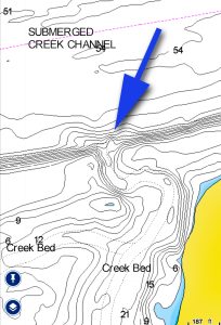 This is an example of an area where Capt. Aaron Massey might begin his search for wintertime blues. The blue arrow points to the mouth of an underwater creek emptying into the main channel of the Tennessee River. 