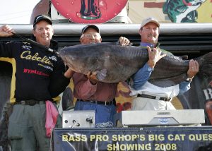Phil King (left) stands with teammates Leland Harris and Tim Haynie at the Bass Pro Shop’s Big Cat Quest weigh-in. King described catching the 103-pound fish as “a dream come true.”