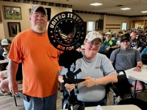 Beth Seeman and Disabled Veterans Outdoors President Ed Halsey enjoying camaraderie with other veterans after a day of catfishing.