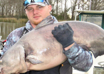 Jim Page is shown with the 60-pound blue that led him to refit his livewell with a new recirculating pump and aerator so he could keep fresh water in the well at all times.