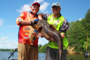 Brothers Rodney Crimm (left) and Michael Haney pose with Michael’s personal best flathead from the Alabama River. (Keith Sutton photo)