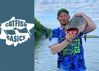 Photo of Joseph Scott Junior holding a blue after he mixed his catfish bait and rigs.