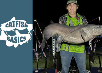 photo of Chandler Highnote holding blue catfish after a successful trip shallow water fishing