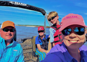 Roy and Holly Sweat Harkness practice water safety beginning with life jackets on the kids. They are shown here with their sons on a fishing adventure. Hunter is 15 years old and Luke is 11.