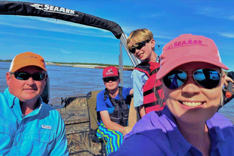 Roy and Holly Sweat Harkness practice water safety beginning with life jackets on the kids. They are shown here with their sons on a fishing adventure. Hunter is 15 years old and Luke is 11.