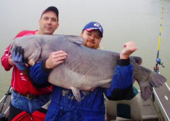 (Photo courtesy of Mike Mitchell) Want to catch a monster catfish like this? Winter is prime time at hotspots that include Alabama’s Wheeler Lake where Joe Ludtke (left) landed this 102-pounder in February 2010. | Lakes for Winter catfishing