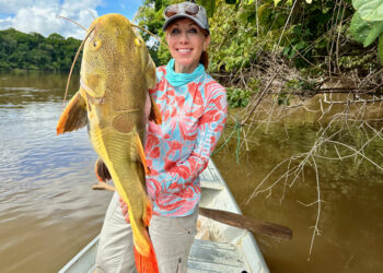 Anietra Hamper holding a redtail catfish caught in the morning hours on the Essequibo River.