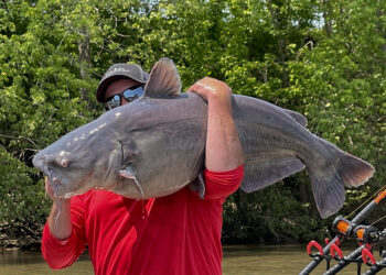 Chris Souders holding a fish on his shoulder