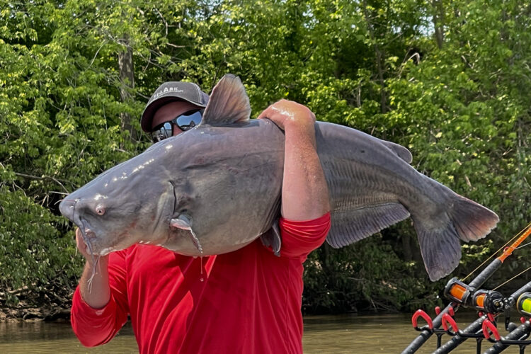Chris Souders holding a fish on his shoulder