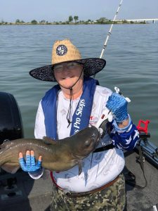 Veteran Beth Seeman proudly holds a prized catch from the Disabled Veterans Outdoors catfishing weekend.