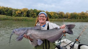 Stephanie, who was part of a veteran event the author guided for, shows off a giant Red River channel catfish. The fish started the day sluggish and in OFF current seams in new water that was recently learned before the trip.