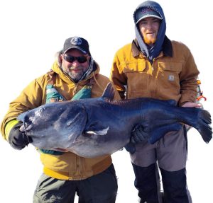 Big winter blues are on the Mitchells’ radar as a client hefts a big wintertime blue with Jackson Mitchell on the right. Photos courtesy of Mike and Jackson Mitchell