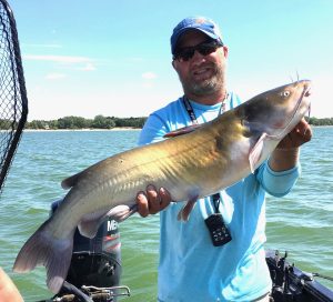 Merritt Reservoir in the Nebraska Sandhills holds some trophy channel catfish like the one guide Tyler Brown holds here.