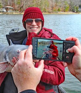 Marc Cooper does a huge amount of marketing for his guiding and bait business on social media, so it is no wonder that he never misses an opportunity to snap photos of Katie and big fish. (Photo: Richard Simms)