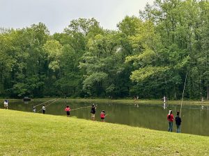 Children learning how to fish during a field trip at the Alabama Nature Center. (Photo courtesy of Alabama Nature Center)