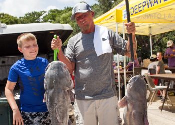 Morgan City Oilfield Fishing Rodeo angler Jacob Aucoin (right) shows off two blue catfish during the 2025 event in Morgan City. His fish on the left weighed 37.78 pounds, good enough for third place during the event.
