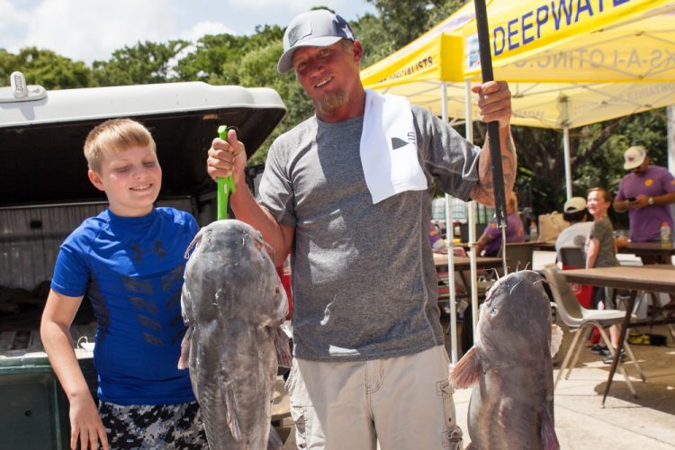 Morgan City Oilfield Fishing Rodeo angler Jacob Aucoin (right) shows off two blue catfish during the 2025 event in Morgan City. His fish on the left weighed 37.78 pounds, good enough for third place during the event.
