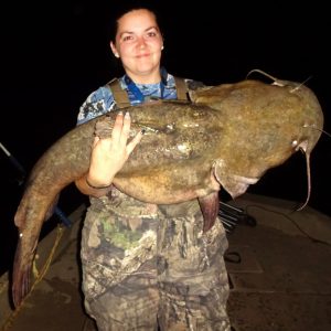 Fishing with Capt. Aaron Massey, Kristen Irby captured a flathead that challenged her ability to hold the fish up for a photo.