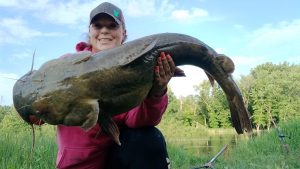 Minnesota angler Christina Lemke holds a great flathead caught from shore in the Minnesota River. (Photo by Brad Durick)