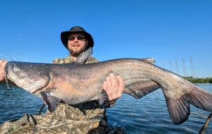 The author's son, Brian, with a big blue caught on Chickamauga Lake fishing vertical on a specific target.  (Photo by Terry Madewell)