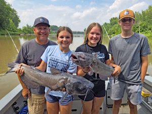 Mike Yoder (left) from Devils Lake, North Dakota brings his three grandkids for a day of catfishing every season. Yoder has been fishing with Capt. Durick since 2014.