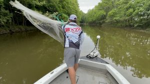 Joey Pounders throwing a cast net for live shad. (Photo by Anietra Hamper)