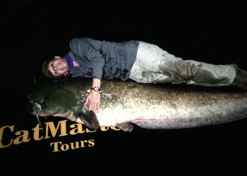 Anietra Hamper measuring up size against a 7.5-foot-long wels catfish caught in the River Ebro in Spain